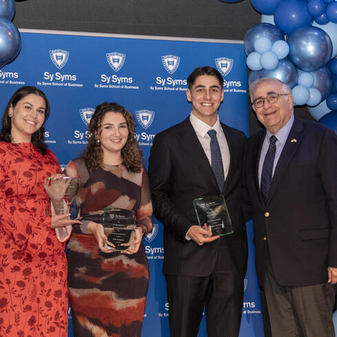 (L-R) Hadaya Fried, Mila Krugman and Andrew Jacobson receiving the President Emeritus Richard Joel Award for Presidential Leadership from YU President Emeritus Richard Joel (far right). (Photo: Adena Stevens)